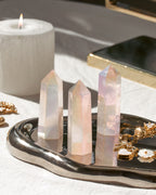 3 Rose Quartz Aura mini gemstone towerS with iridescent coating sitting on silver tray.