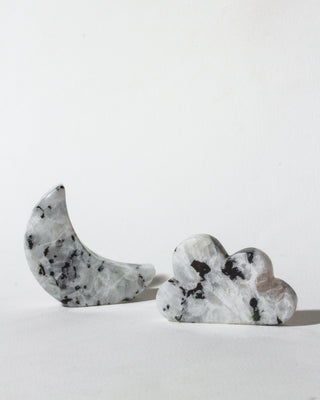 Decorative stone moon and cloud shapes on a white background