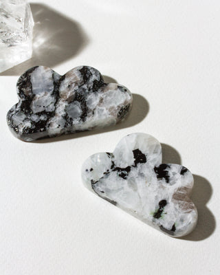 2 cloud shaped moonstone gemstones showing color variance.