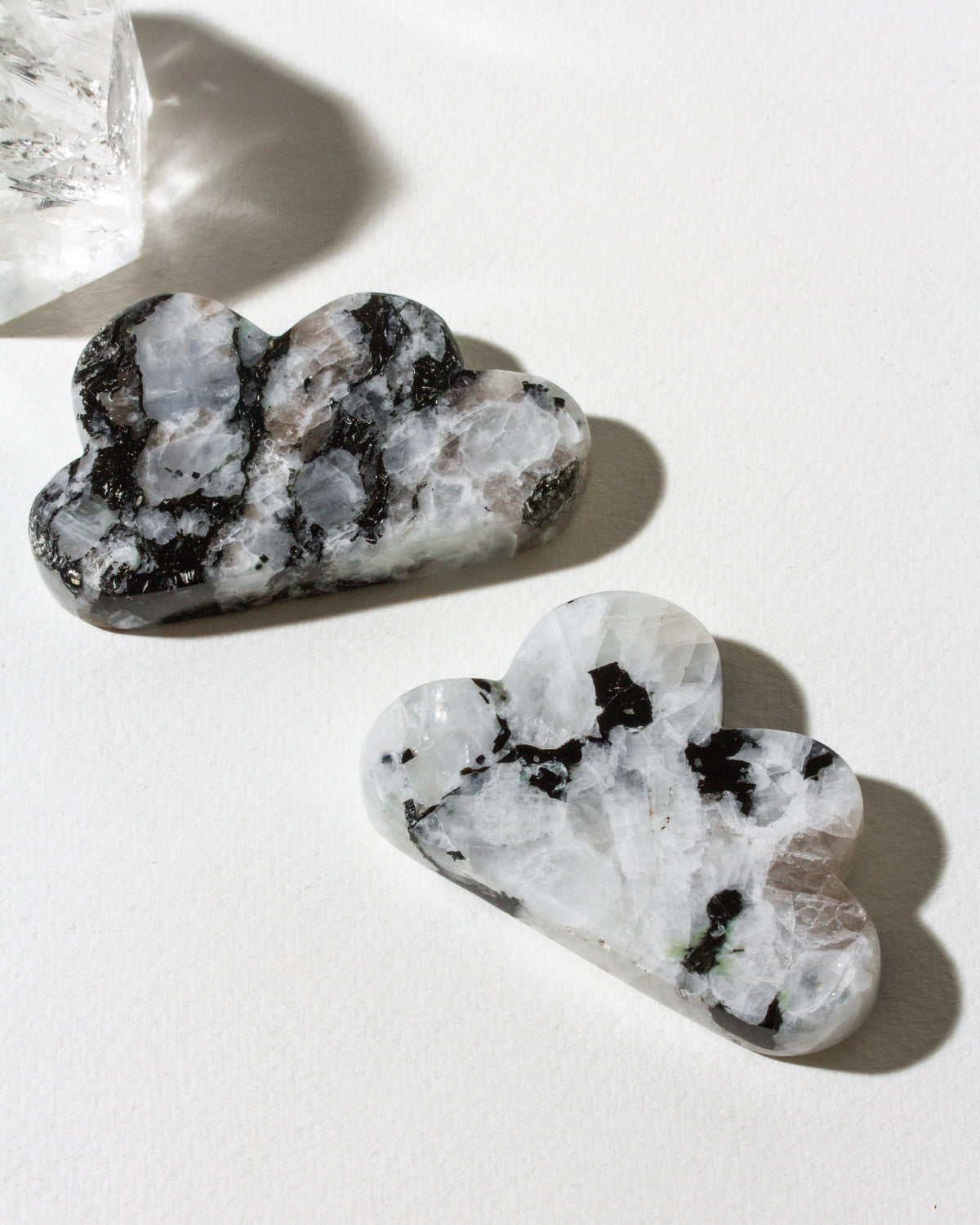 2 cloud shaped moonstone gemstones showing color variance.