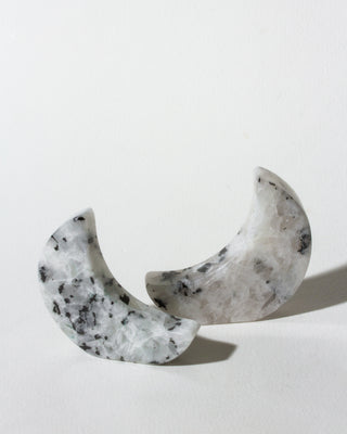 Marble-patterned crescent-shaped earrings on a light gray background