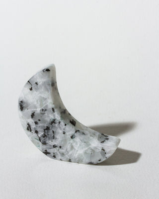 Marble-patterned crescent-shaped object on a light gray background