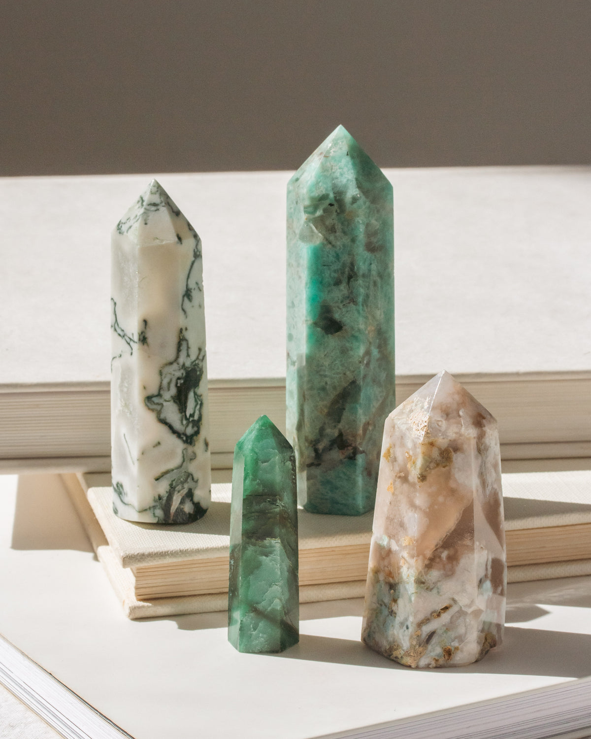 Set of four standing crystal towers has Moss Agate, Amazonite, Green Aventurine, and Blossom Agate.