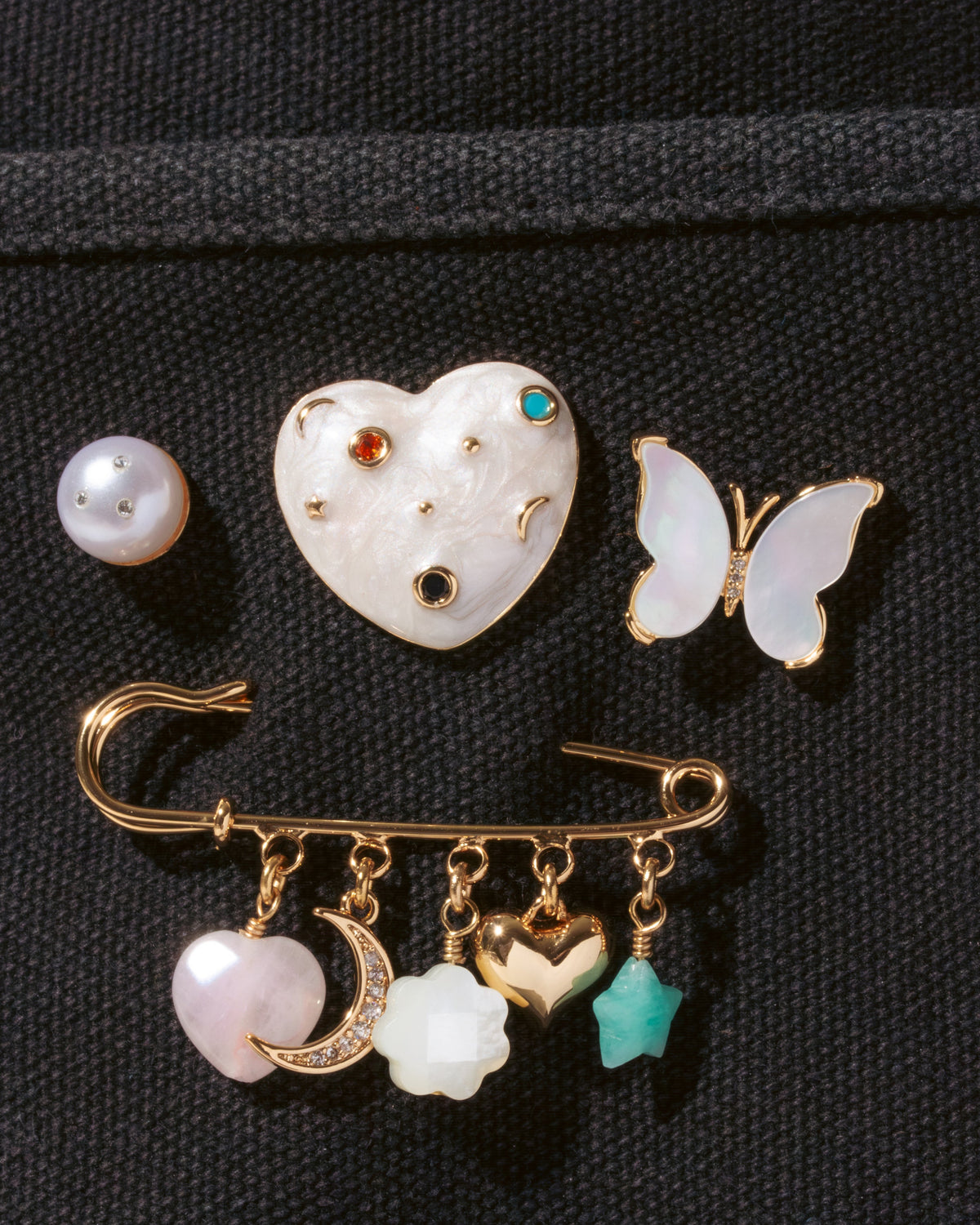 4 piece pin set featuring Mother of Pearl Butterfly, faux pearl stud, enamel heart and safety pin with charms.