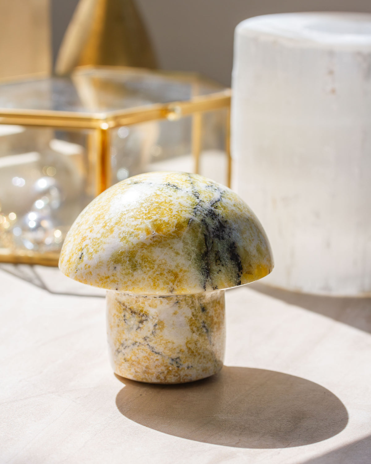 A mushroom or toadstool-shaped Serpentine gemstone with forest-like colors