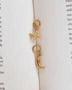 Pair of gold hoop earrings, one in the shape of a crescent moon, the other a star with CZ elements