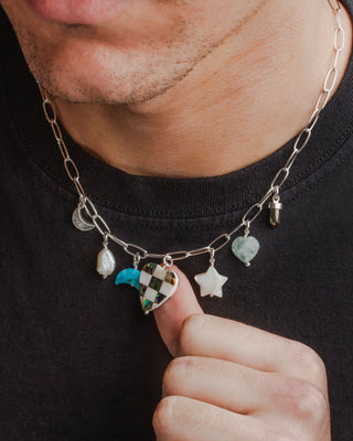 Silver chain necklace with various heart, star, moon, and bead charms.