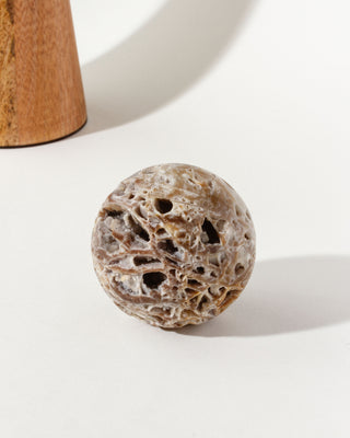 Sphalerite Gemstone sphere with marble earth tones and veined surface on a white background.
