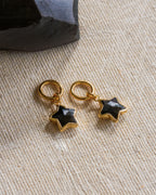 Two hoop earrings with star-shaped black onyx gemstones attached to them