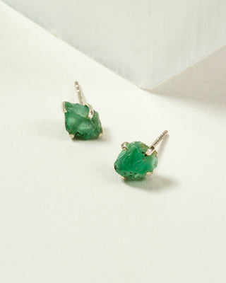 Emerald Raw Beauty Birthstone Post Earrings on a white tabletop