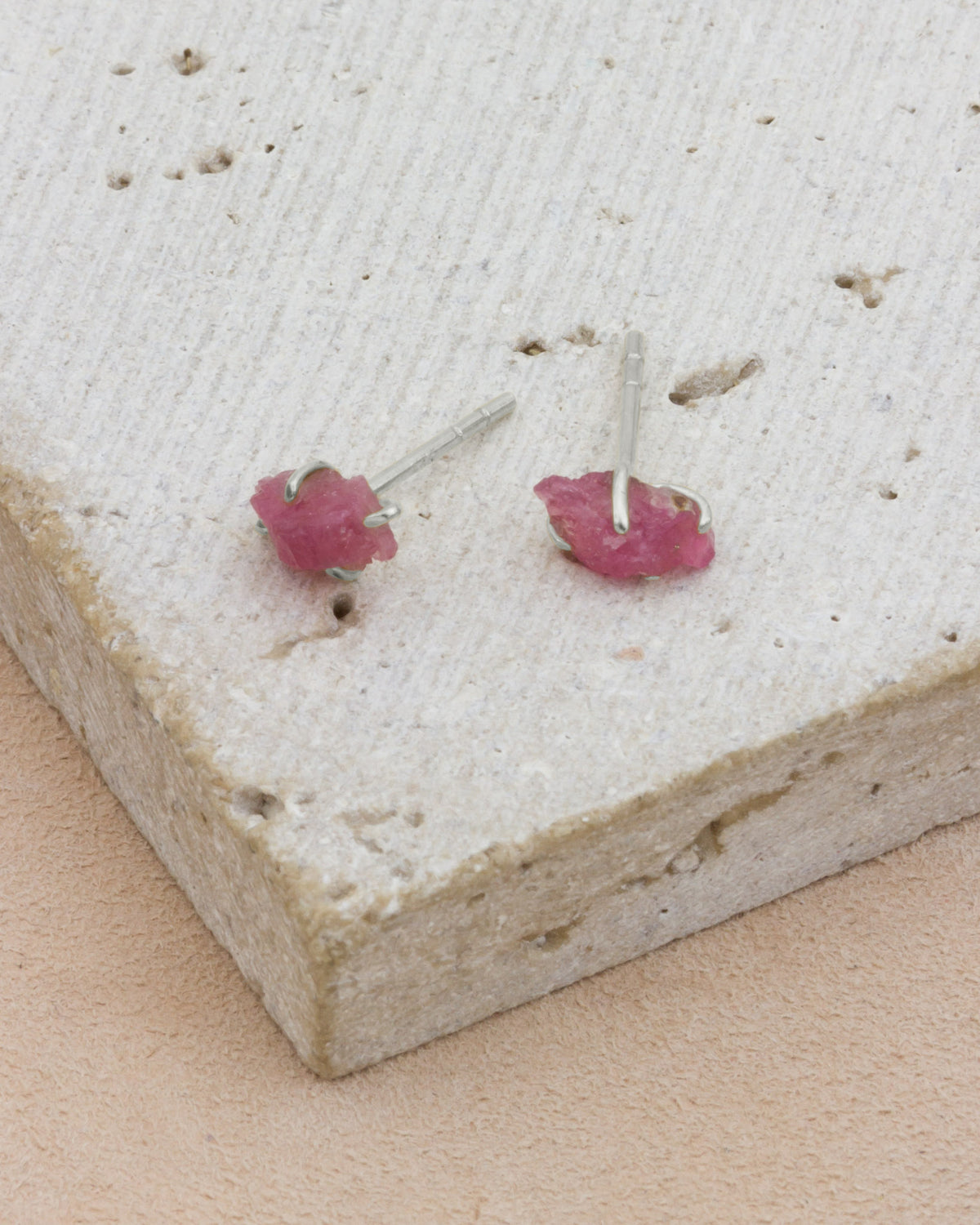 Pink Tourmaline Raw Beauty Birthstone Post Earrings on a white tabletop
