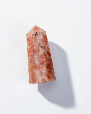 Small Sunstone obelisk tower on a white background.