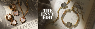 Jewelry set with gold and stone elements on a textured surface with 'The Envy Edit' text.