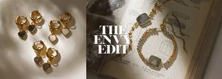 "The Envy Edit" Holiday 2023, Shadowy Earrings, Necklace, & Bracelet flatlay on books