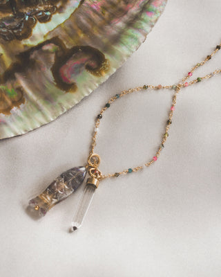 Necklace with fish quartz pendants on a textured surface