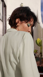 Person models gold earrings and necklace.