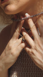 Video of model wearing and coffee moonstone heart necklace.