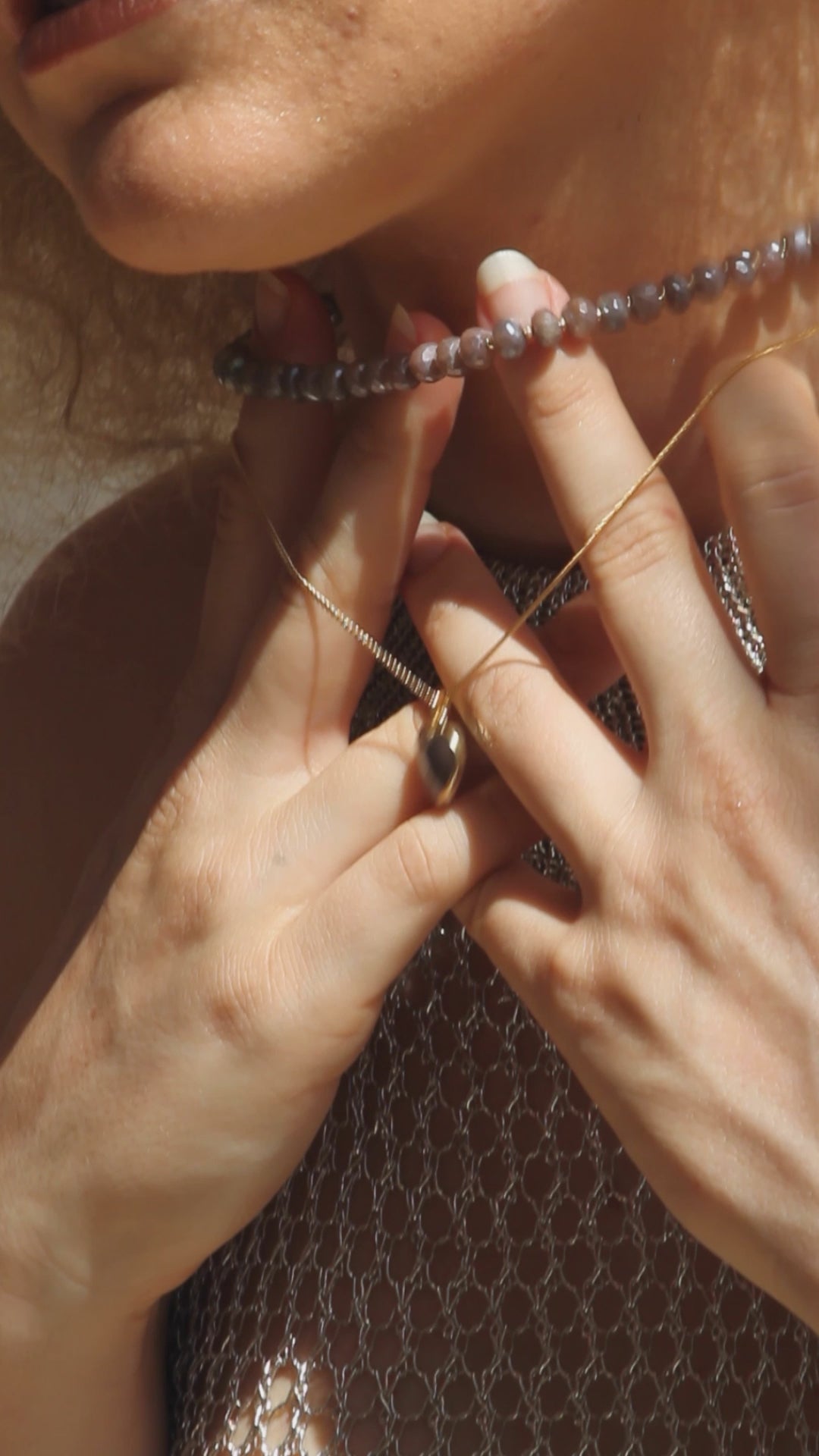 Video of model wearing and coffee moonstone heart necklace.