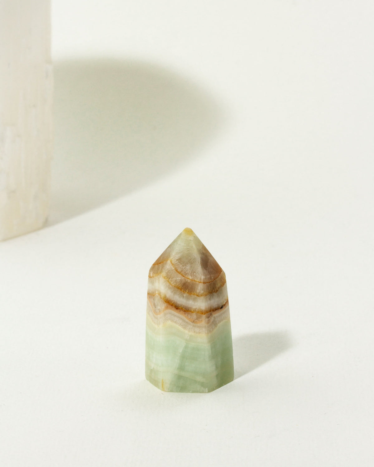 Caribbean Calcite Gemstone Mini Tower with layered green and brown coloring.