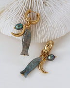 Close-up of the Tapas & Tides huggie hoop earring shows the labradorite charm