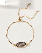 Gold adjustable bracelet featuring a tourmalinated quartz gemstone.