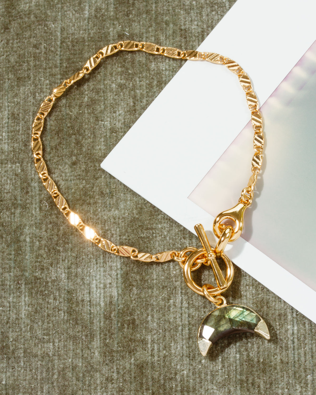 Gold chain Crescent Horn Toggle Bracelet with Labradorite gemstone pendant.