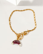 Gold Crescent Horn Toggle Bracelet with a ruby gemstone crescent horn charm.