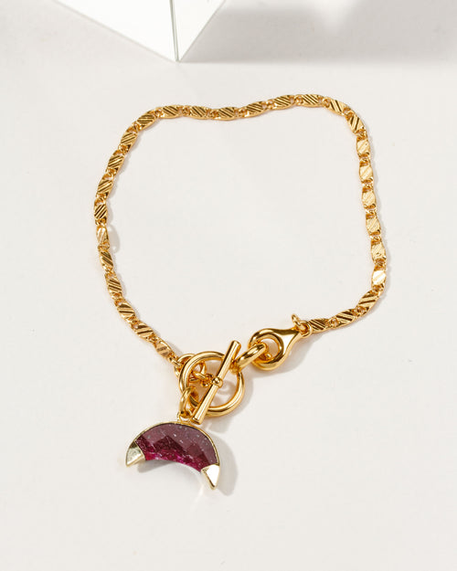 Gold Crescent Horn Toggle Bracelet with a ruby gemstone crescent horn charm.