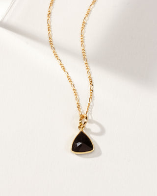 Close up of Onyx  Bermuda Triangle Dainty Collar Necklace with a 14 Karat Gold Plated Brass chain laying on a white background.