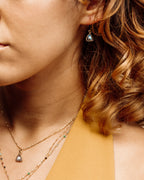 Model wearing howlite Bermuda Triangle pendant necklace