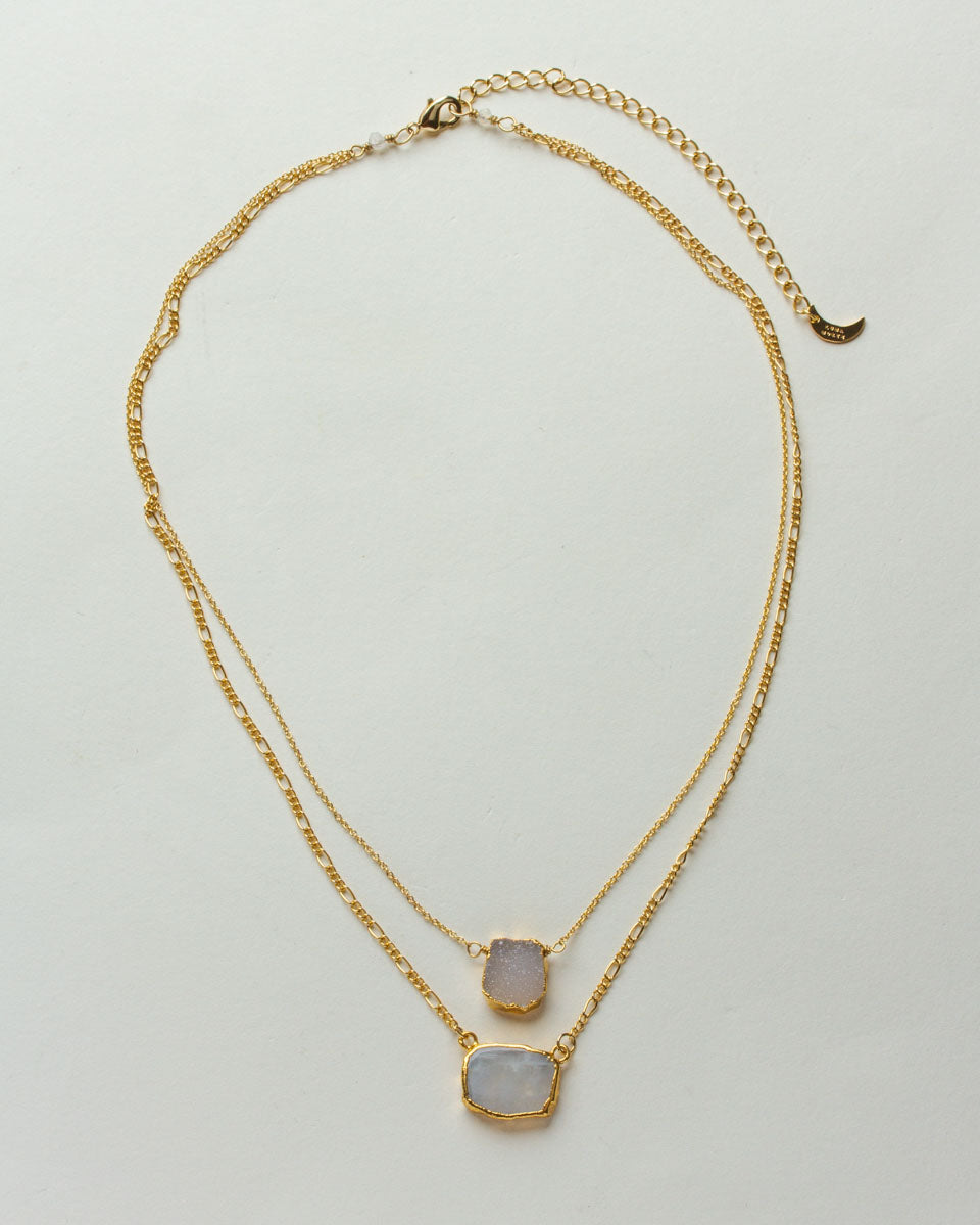 Gold-toned layered necklace with druzy and rainbow moonstone pendants.