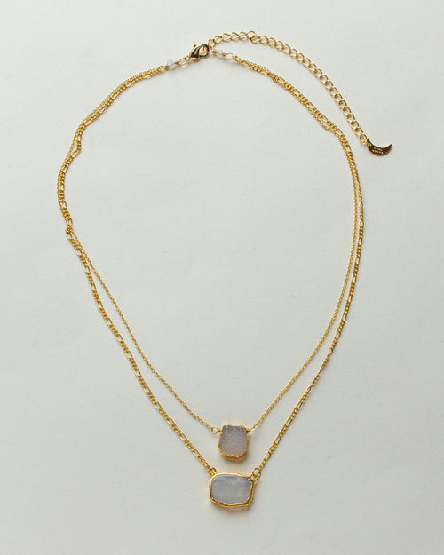 Gold-toned layered necklace with druzy and rainbow moonstone pendants.