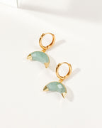 Crescent horn huggie hoop earrings with Aquamarine gemstones and gold-tone hardware.