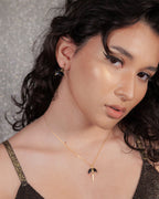 Crescent Horn Huggie Hoop Earring in Onyx on model.