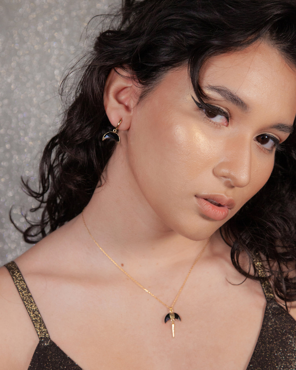 Crescent Horn Huggie Hoop Earring in Onyx on model.