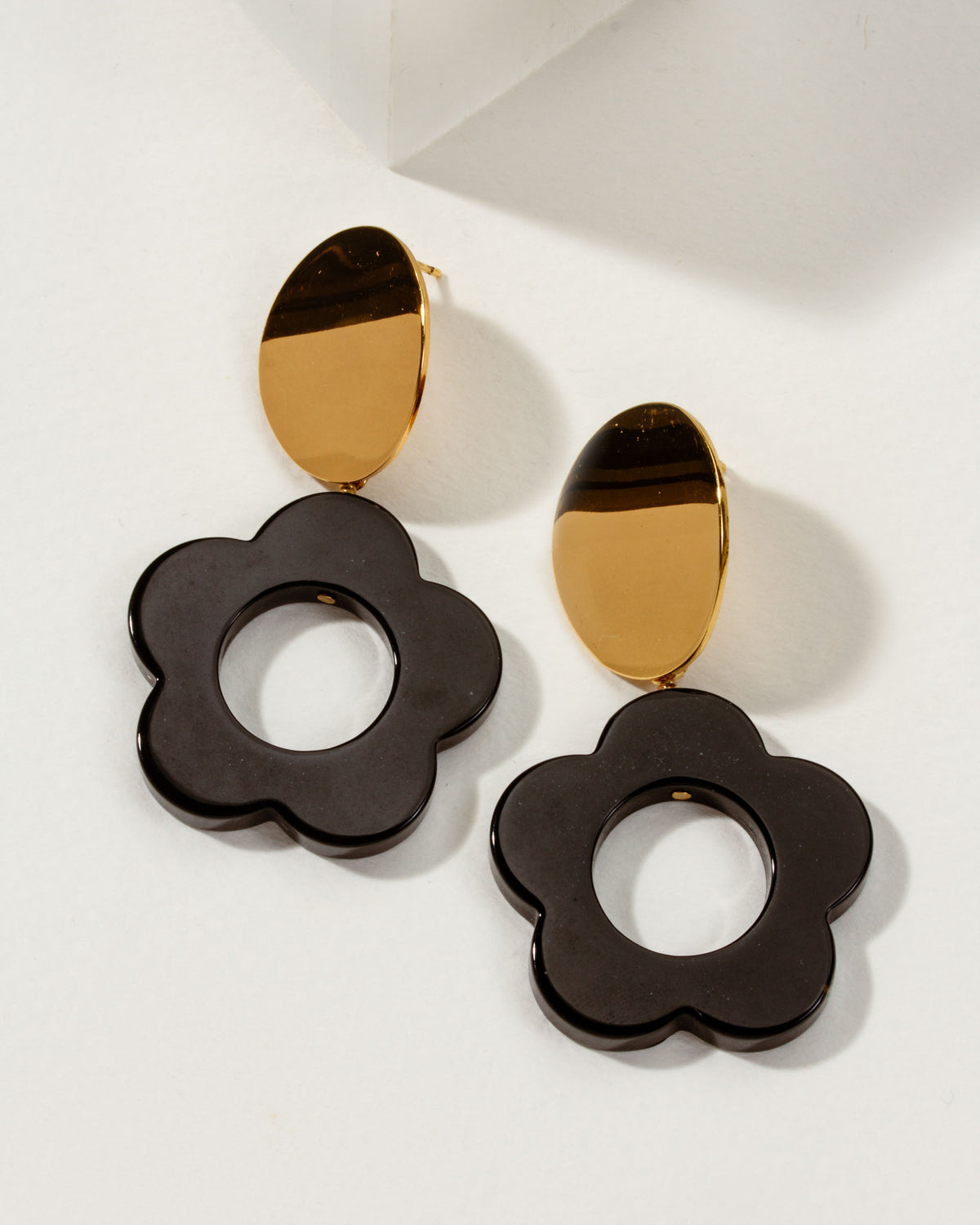 Oops-A-Daisy Earrings with gold accents and dark brown flower detail.