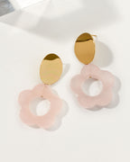 Oops-A-Daisy earrings with gold hardware and rose quartz carved gemstone in a flower shape.
