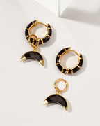 Gold hoop earrings with black enamel and faceted onyx gemstone charms.