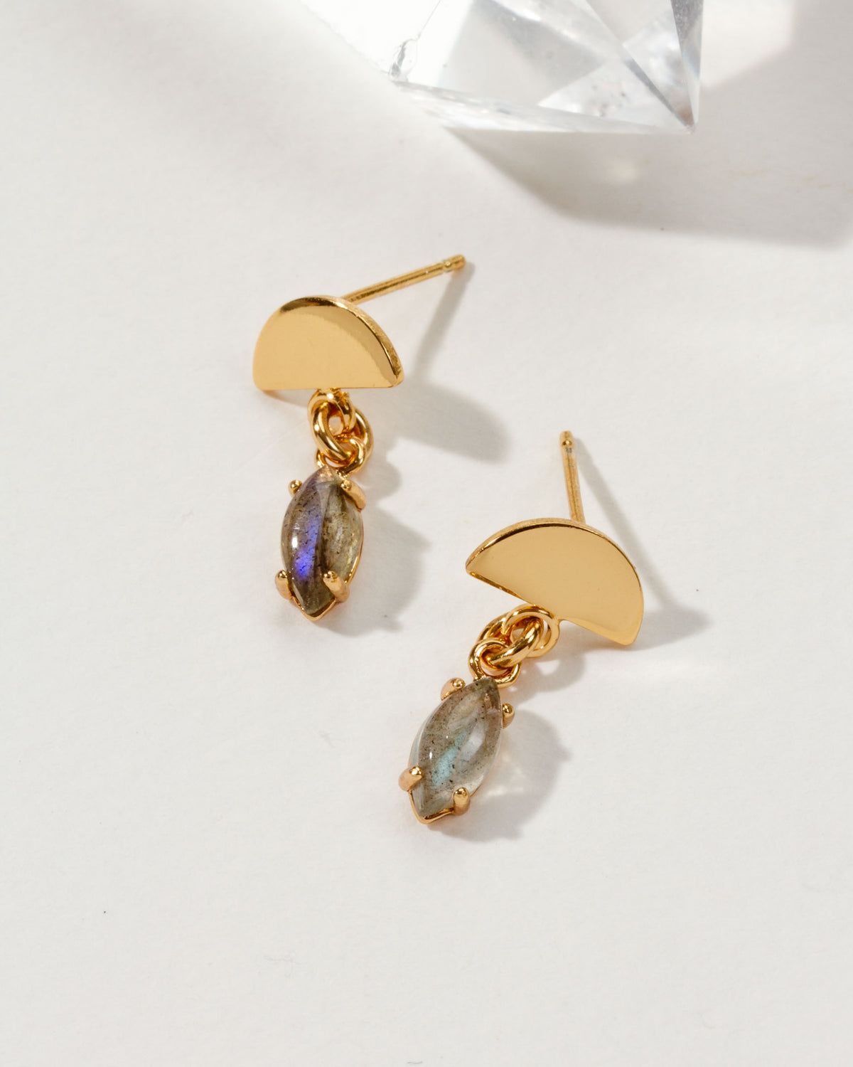 Pair of gold post earrings with semi-circle accent and marquise-cut labradorite gemstone.