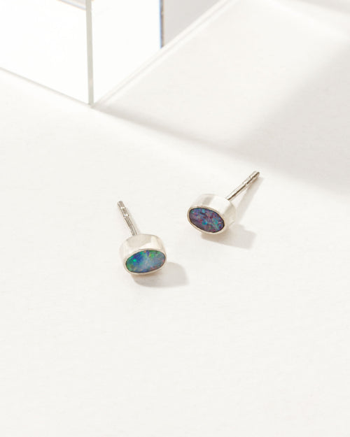Oval Blue Wave Opal earrings with a sterling silver bezel.