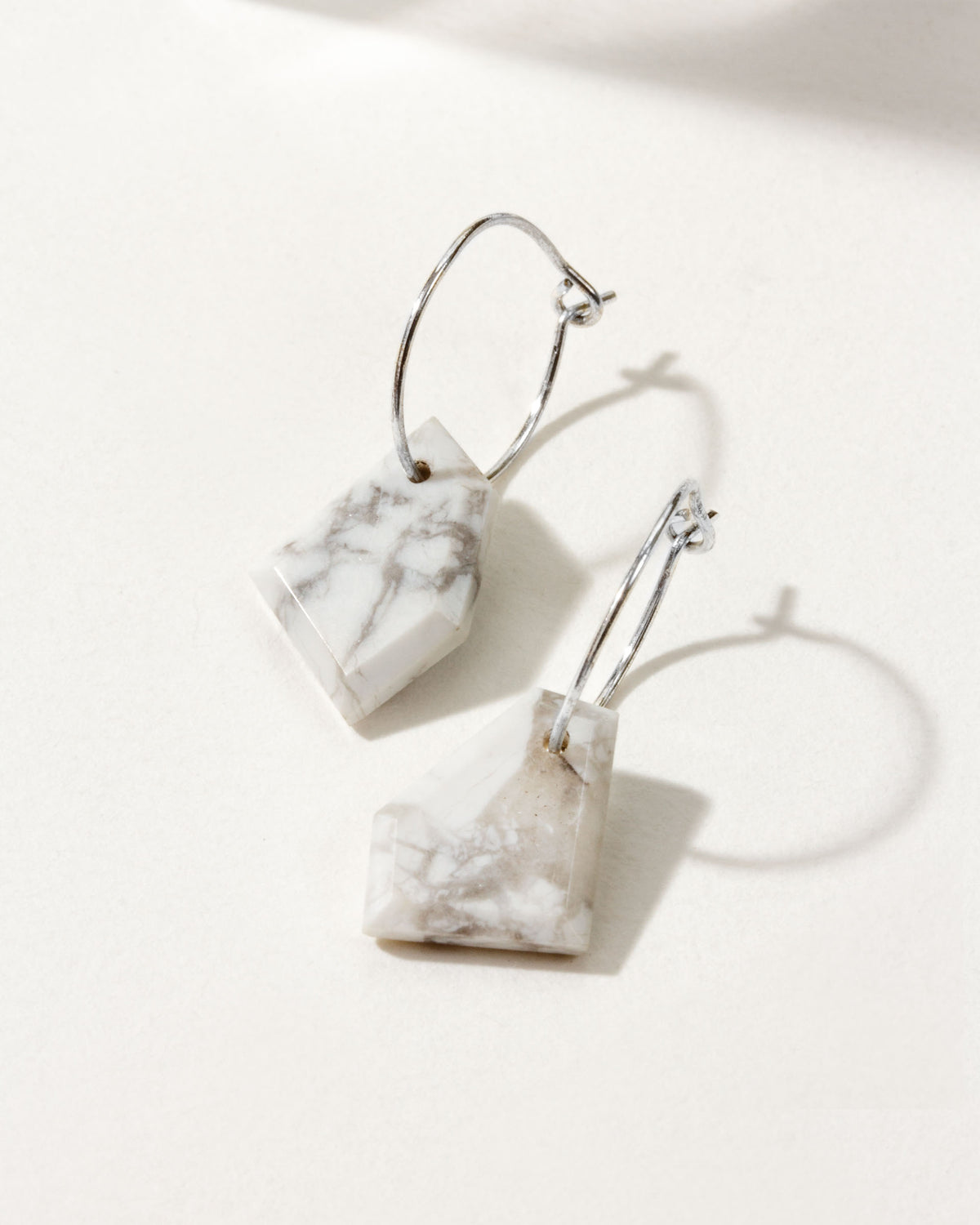 Hoop earrings with faceted Howlite stones and Sterling Silver hardware.