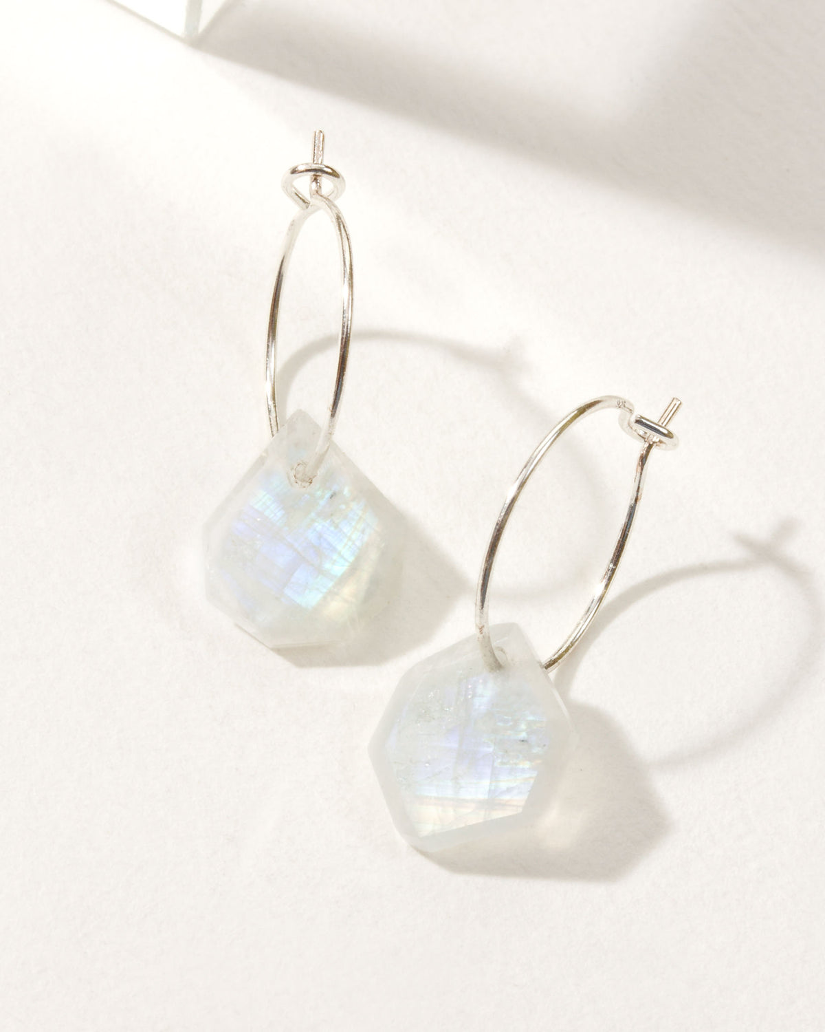 Sterling Silver Geometry Mini Hoops with Moonstone gems, with faceted design and silver hardware.