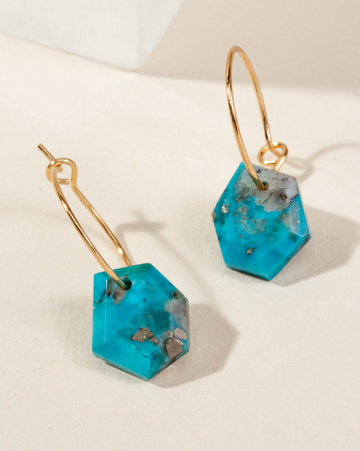 Geometry Mini Hoops in Turquoise with gold-plated silver hoops, with stone facets and hoop detail.