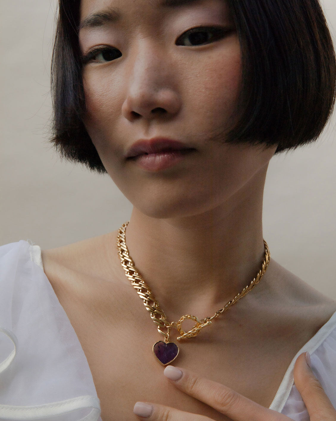 Heart of Gold Toggle Necklace with a gold chain and Amethyst heart-shaped gemstone.