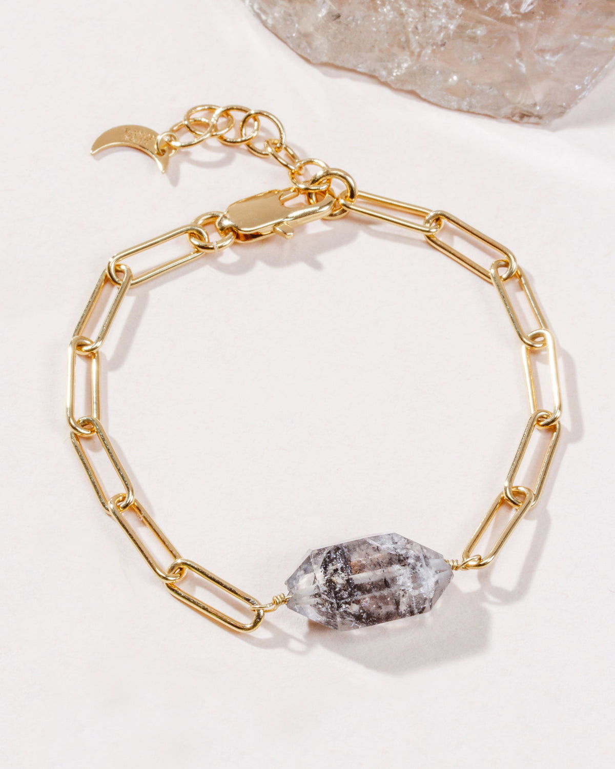 Gold chain bracelet featuring a Herkimer Quartz stone with black inclusions.