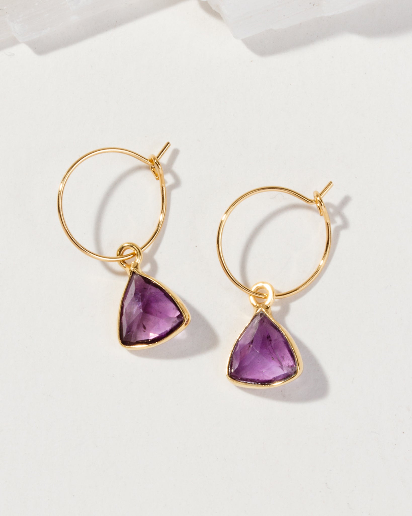 Bermuda Triangle Mini Hoops featuring a pair of gold earrings with Amethyst gemstones.