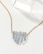 Rainy Day necklace in Ice Blue with a gold chain.