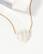 Rainy Day necklace with a Mystic Clear crystal pendant and a gold chain.