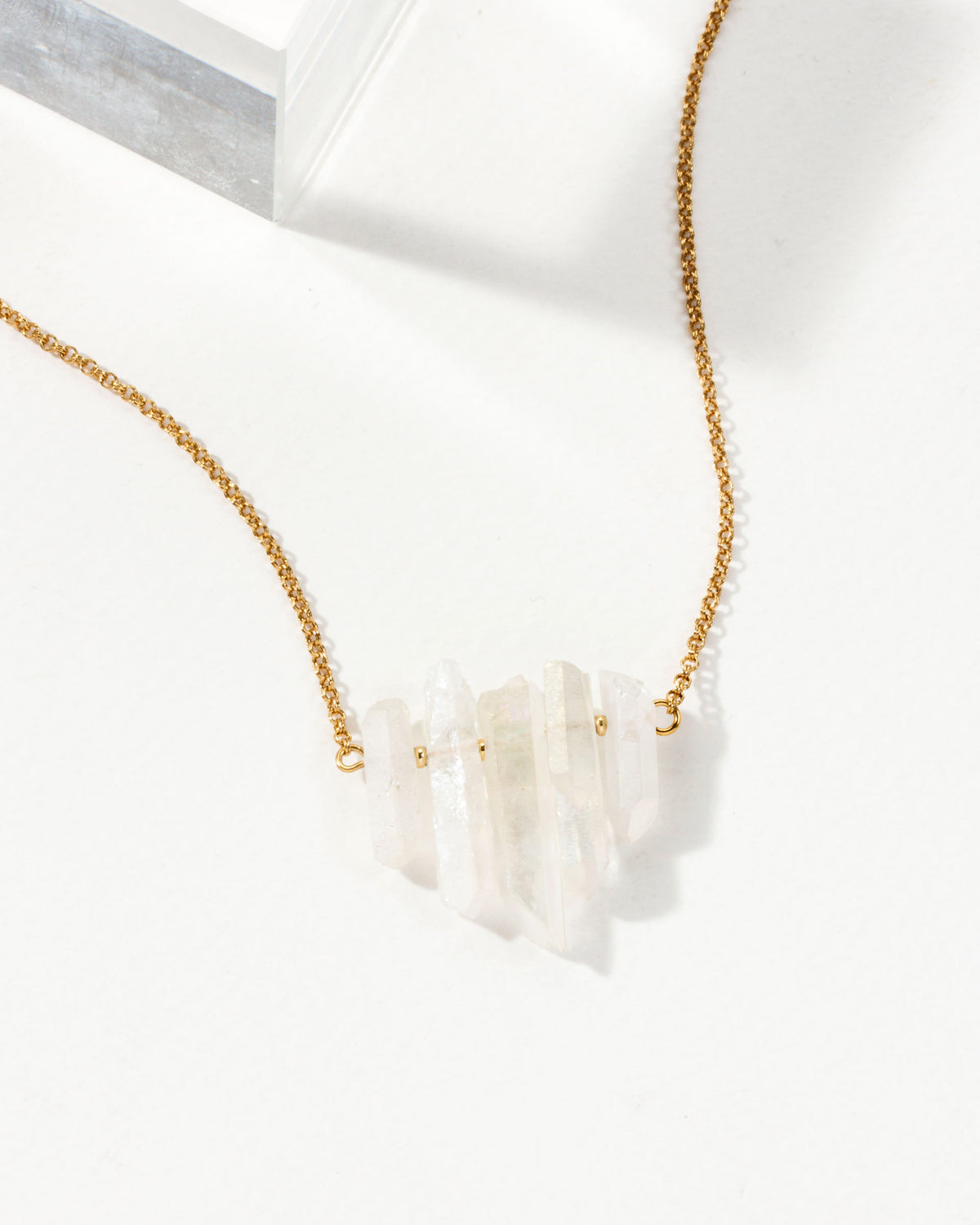 Rainy Day necklace with a Mystic Clear crystal pendant and a gold chain.