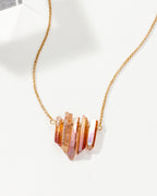 Rainy Day necklace with peach crystal shards on a gold chain.